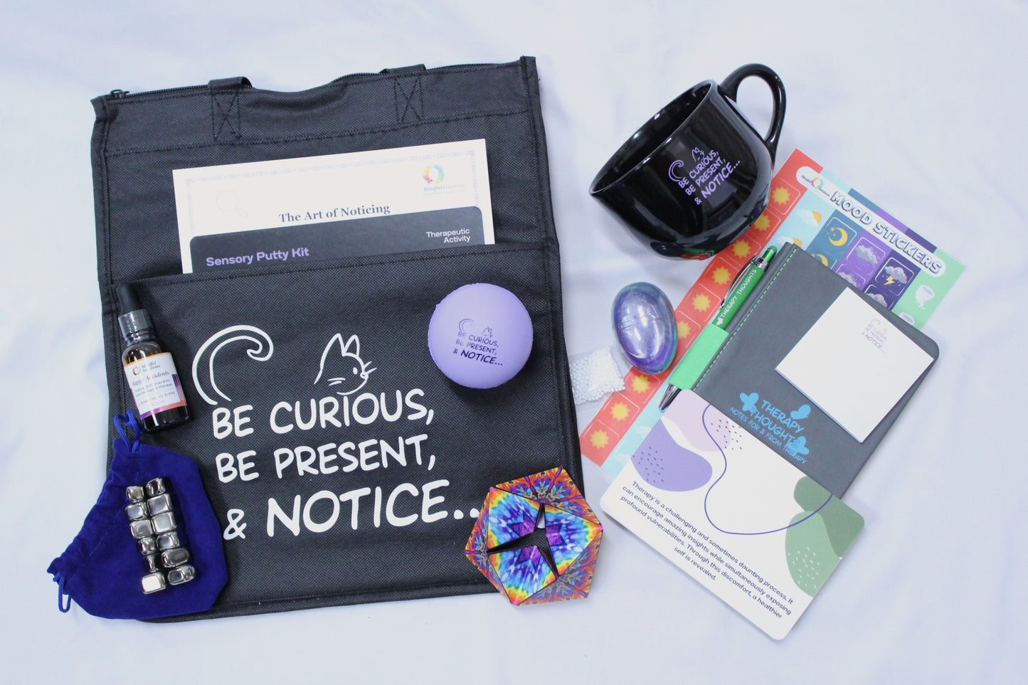 blue tote bag with essential oil, mug, stress ball, note pad, more 2