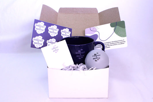 small box with mug, stress ball, stickers