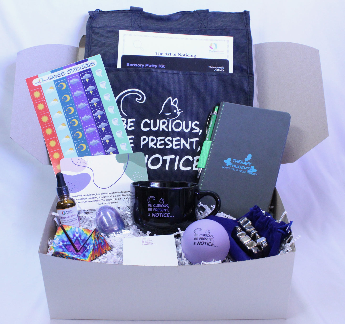 blue tote bag with essential oil, mug, stress ball, note pad, more