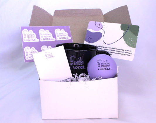 small box with mug, stress ball, stickers, more